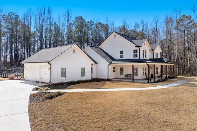 view of front facade with a garage, a front yard, and a porch