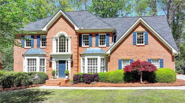 865 Mount Katahdin Trl, Johns Creek, GA 30022 - view of front facade featuring a front lawn, brick siding, and a shingled roof