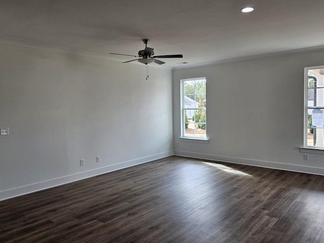 unfurnished room with ornamental molding, dark wood finished floors, and a wealth of natural light