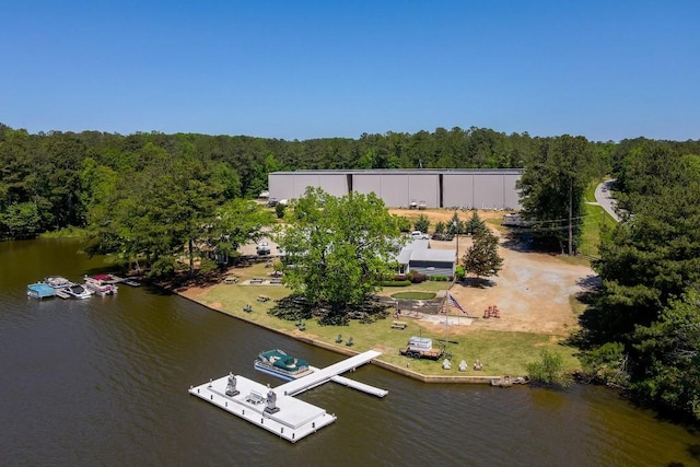 birds eye view of property featuring a water view and a view of trees