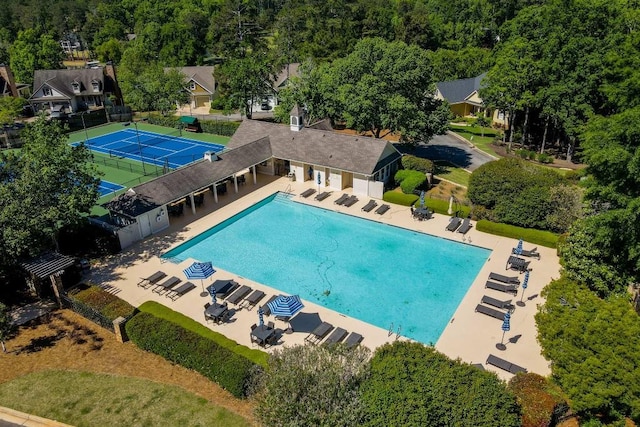 pool with a patio and fence