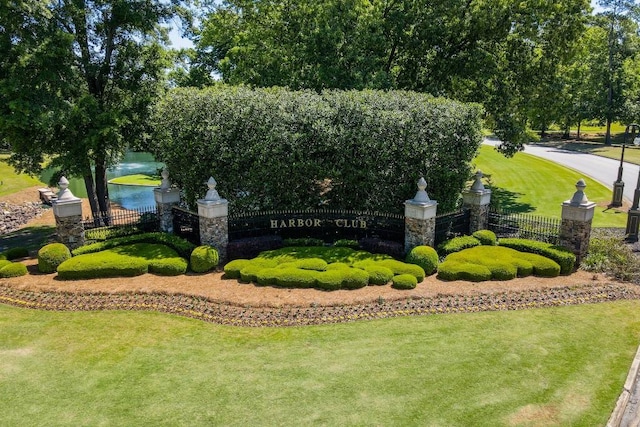 view of home's community with a lawn and fence