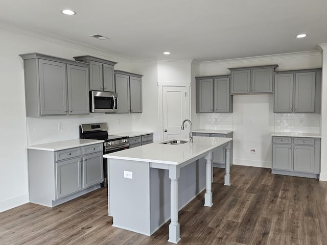 kitchen with stainless steel appliances, a sink, and gray cabinetry