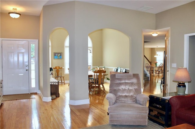 265 Mona Ct, Winder, GA 30680 - foyer entrance with stairs, light wood-type flooring, arched walkways, and baseboards