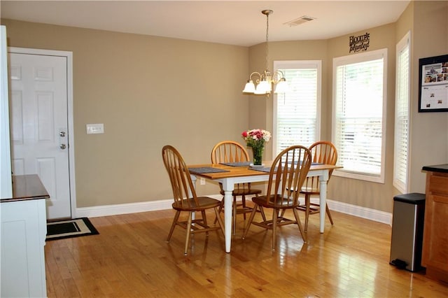 265 Mona Ct, Winder, GA 30680 - dining room with baseboards, light wood finished floors, and a chandelier