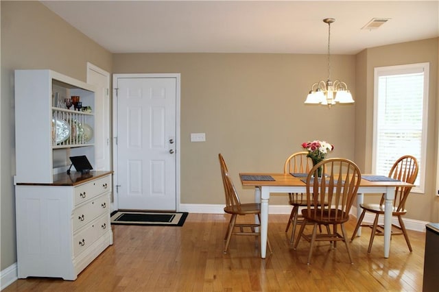 265 Mona Ct, Winder, GA 30680 - dining space with a chandelier, baseboards, and light wood-type flooring