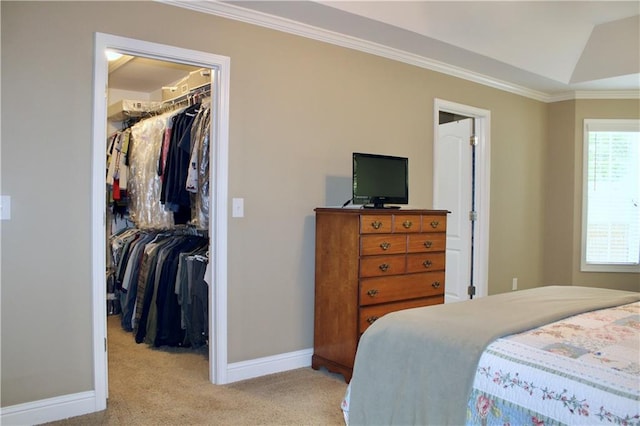 265 Mona Ct, Winder, GA 30680 - bedroom with a walk in closet, a closet, light carpet, baseboards, and crown molding