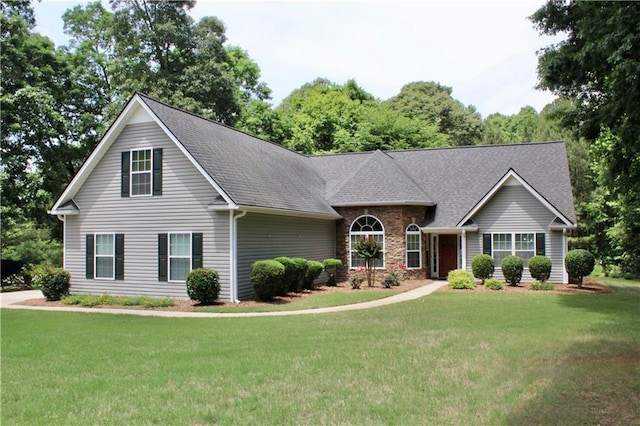 265 Mona Ct, Winder, GA 30680 - view of front of home with a front lawn, roof with shingles, and stone siding