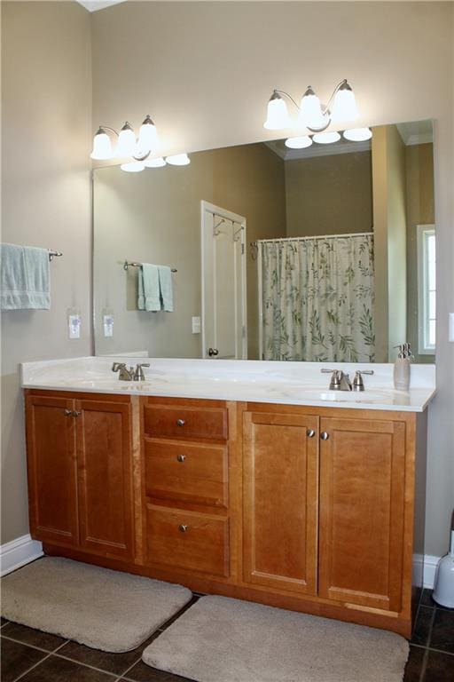 265 Mona Ct, Winder, GA 30680 - bathroom featuring tile patterned floors, double vanity, and baseboards