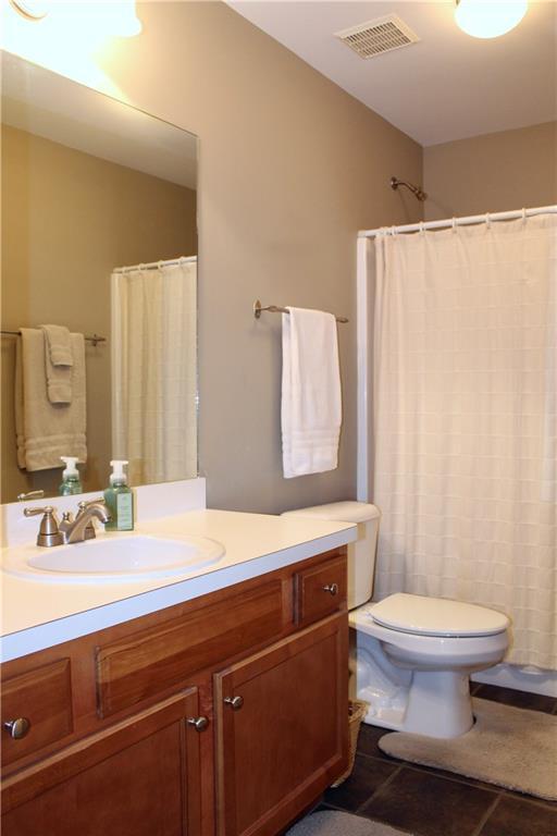265 Mona Ct, Winder, GA 30680 - bathroom with toilet, vanity, tile patterned flooring, and curtained shower