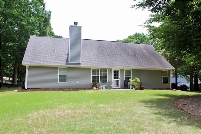 265 Mona Ct, Winder, GA 30680 - rear view of property featuring a lawn, a chimney, and a shingled roof