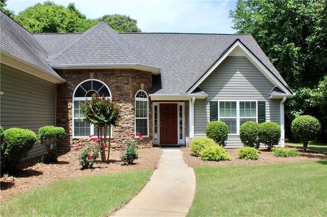 265 Mona Ct, Winder, GA 30680 - view of front facade with stone siding, a front yard, and roof with shingles