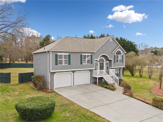 raised ranch with a garage and a front yard