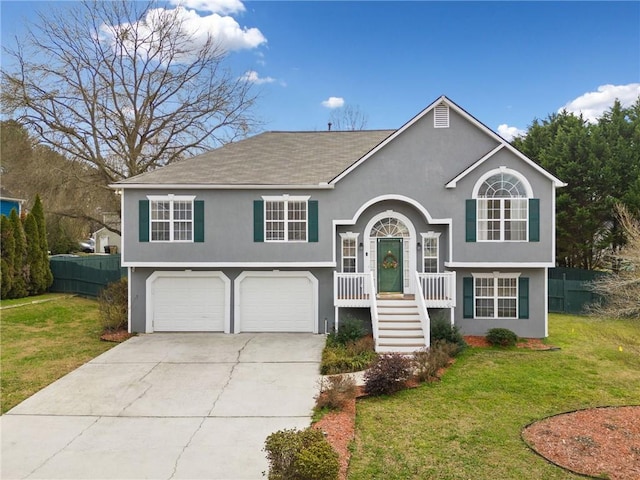 raised ranch with a garage and a front lawn