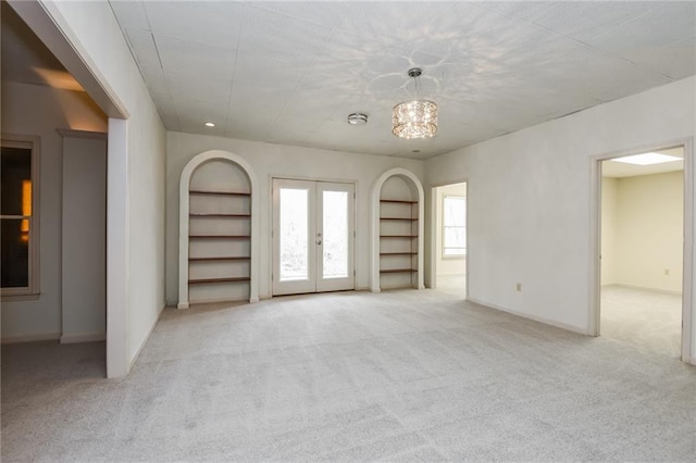 5055 Hickory Hills Dr, Woodstock, GA 30188 - carpeted spare room with built in features, french doors, baseboards, and arched walkways