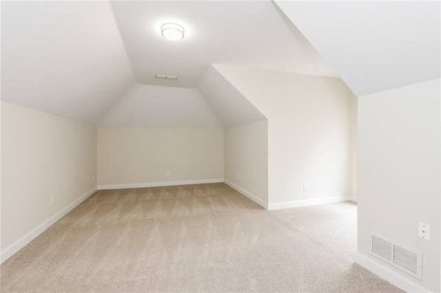 5055 Hickory Hills Dr, Woodstock, GA 30188 - additional living space featuring light carpet, visible vents, baseboards, and lofted ceiling