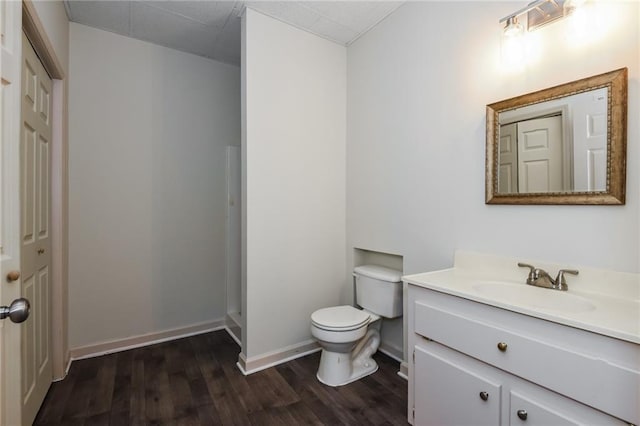 5055 Hickory Hills Dr, Woodstock, GA 30188 - bathroom with toilet, wood finished floors, baseboards, walk in shower, and vanity