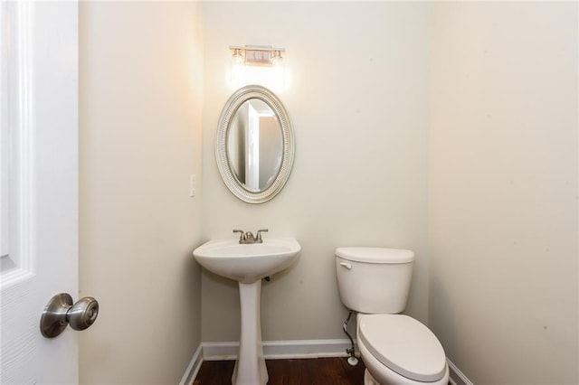 5055 Hickory Hills Dr, Woodstock, GA 30188 - half bathroom with toilet, wood finished floors, and baseboards
