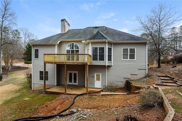 5055 Hickory Hills Dr, Woodstock, GA 30188 - rear view of house featuring a shingled roof, a wooden deck, french doors, a chimney, and a patio area