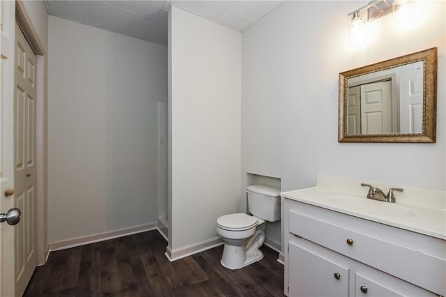 bathroom featuring toilet, hardwood / wood-style flooring, and vanity