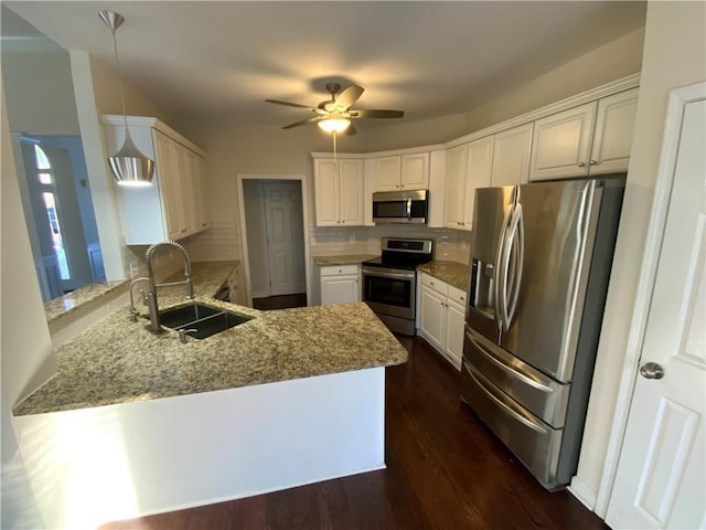 5055 Hickory Hills Dr, Woodstock, GA 30188 - kitchen featuring light stone countertops, a peninsula, a sink, stainless steel appliances, and tasteful backsplash