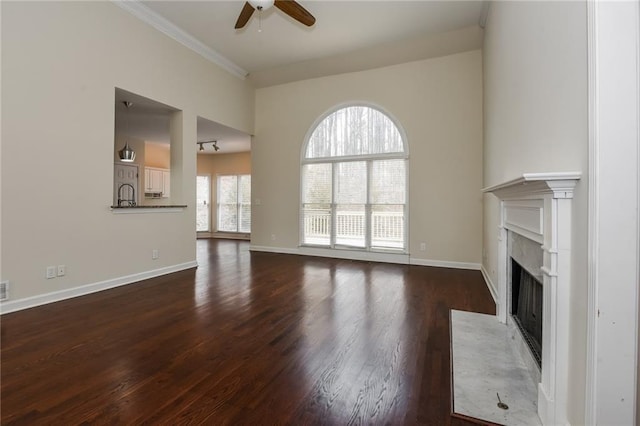5055 Hickory Hills Dr, Woodstock, GA 30188 - unfurnished living room featuring dark wood-type flooring, ceiling fan, baseboards, a fireplace with flush hearth, and ornamental molding