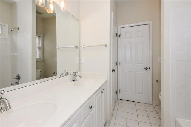 bathroom with toilet, tile patterned floors, and vanity