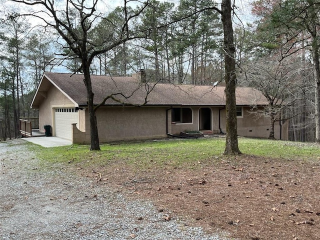 view of front of property featuring stucco siding, a front yard, concrete driveway, and an attached garage