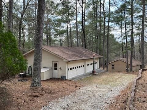 view of side of property featuring driveway and a garage