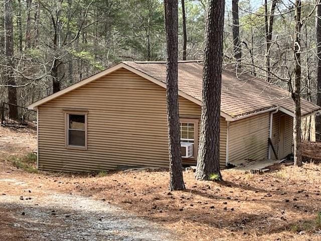 view of home's exterior with a shingled roof