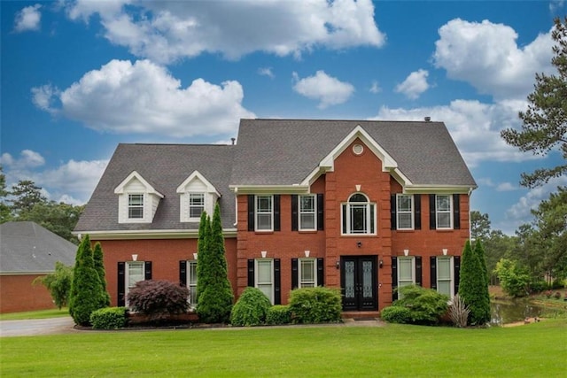 colonial-style house with french doors and a front lawn