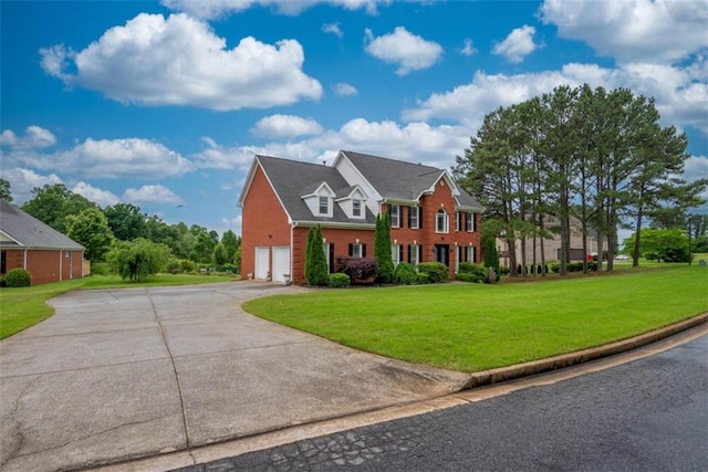 colonial house with a front lawn and a garage