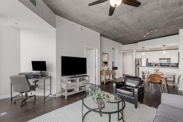 living room with ceiling fan and dark wood-type flooring