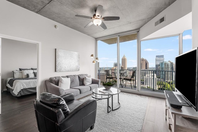 living room featuring hardwood / wood-style flooring, plenty of natural light, floor to ceiling windows, and ceiling fan