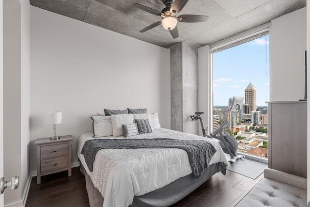 bedroom featuring multiple windows, ceiling fan, and dark wood-type flooring