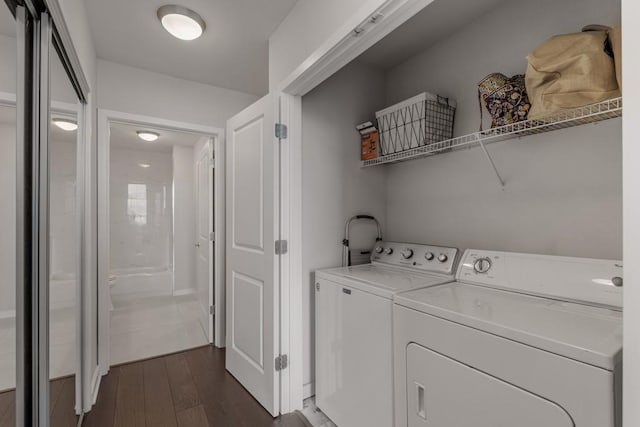 washroom featuring dark hardwood / wood-style floors and washer and clothes dryer