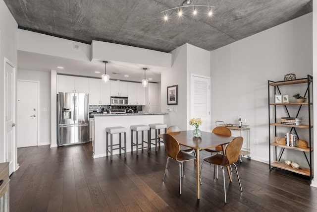 dining space featuring dark wood-type flooring