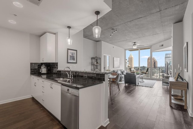 kitchen featuring kitchen peninsula, sink, decorative light fixtures, dishwasher, and white cabinets