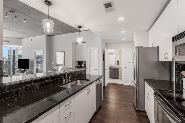 kitchen featuring white cabinetry, sink, dark wood-type flooring, and decorative light fixtures