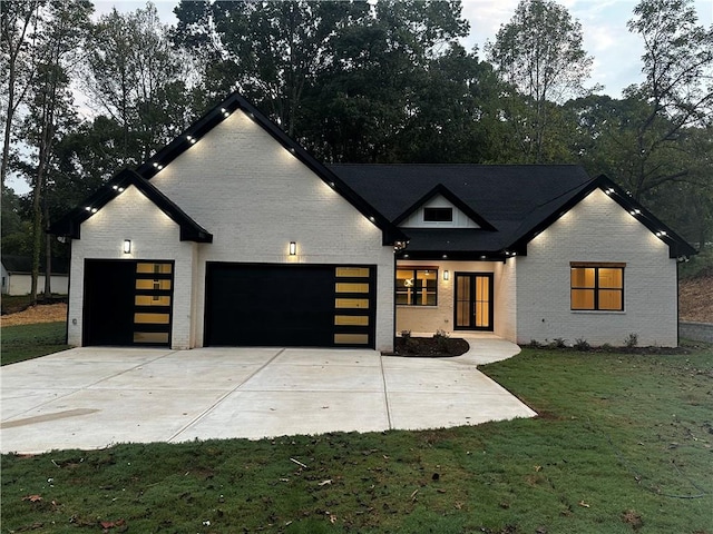 modern farmhouse style home with a front yard and a garage