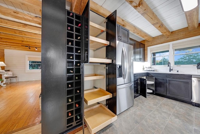 kitchen with wooden ceiling, sink, light hardwood / wood-style flooring, beamed ceiling, and stainless steel appliances