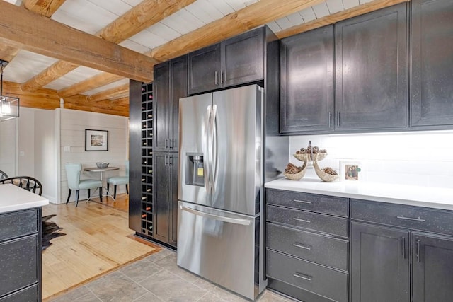 kitchen featuring stainless steel fridge, beamed ceiling, wooden ceiling, and light wood-type flooring