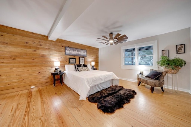 923 Pine Cir, Woodstock, GA 30189 - bedroom with beamed ceiling, light wood-style floors, wooden walls, baseboards, and a ceiling fan