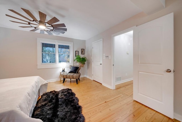 bedroom with hardwood / wood-style floors and ceiling fan