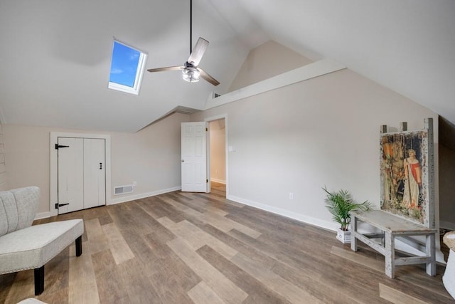923 Pine Cir, Woodstock, GA 30189 - unfurnished room featuring ceiling fan, lofted ceiling, a skylight, wood finished floors, and baseboards