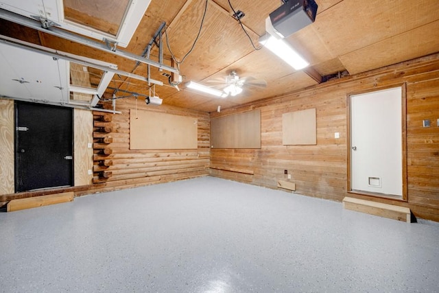 basement featuring ceiling fan and wooden walls