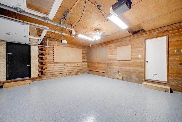 923 Pine Cir, Woodstock, GA 30189 - garage with a garage door opener, a ceiling fan, and wooden walls
