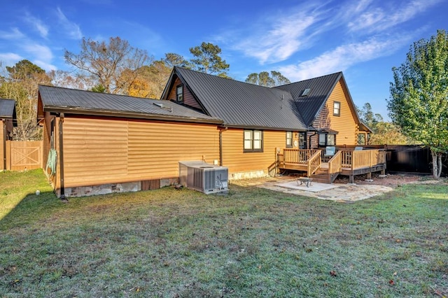 back of property featuring a lawn, cooling unit, a patio area, and a deck