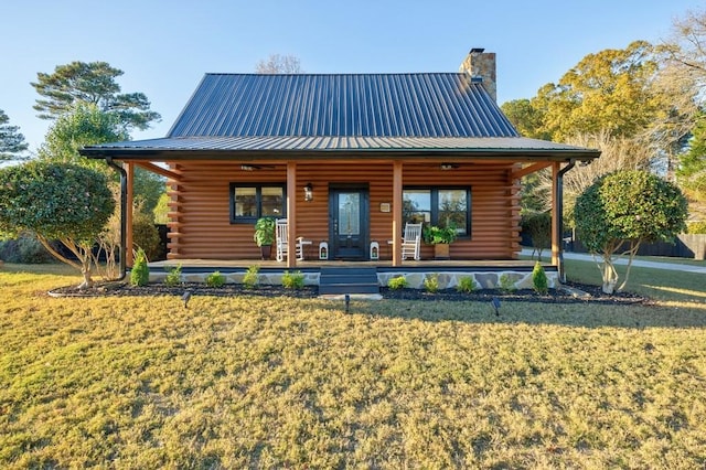 rear view of property featuring covered porch and a yard