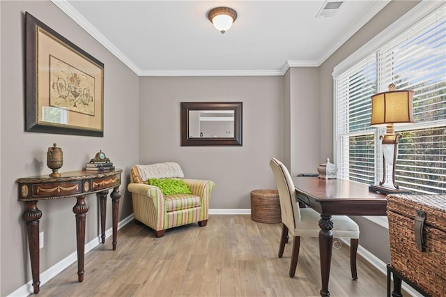 home office with baseboards, visible vents, ornamental molding, and light wood-style floors